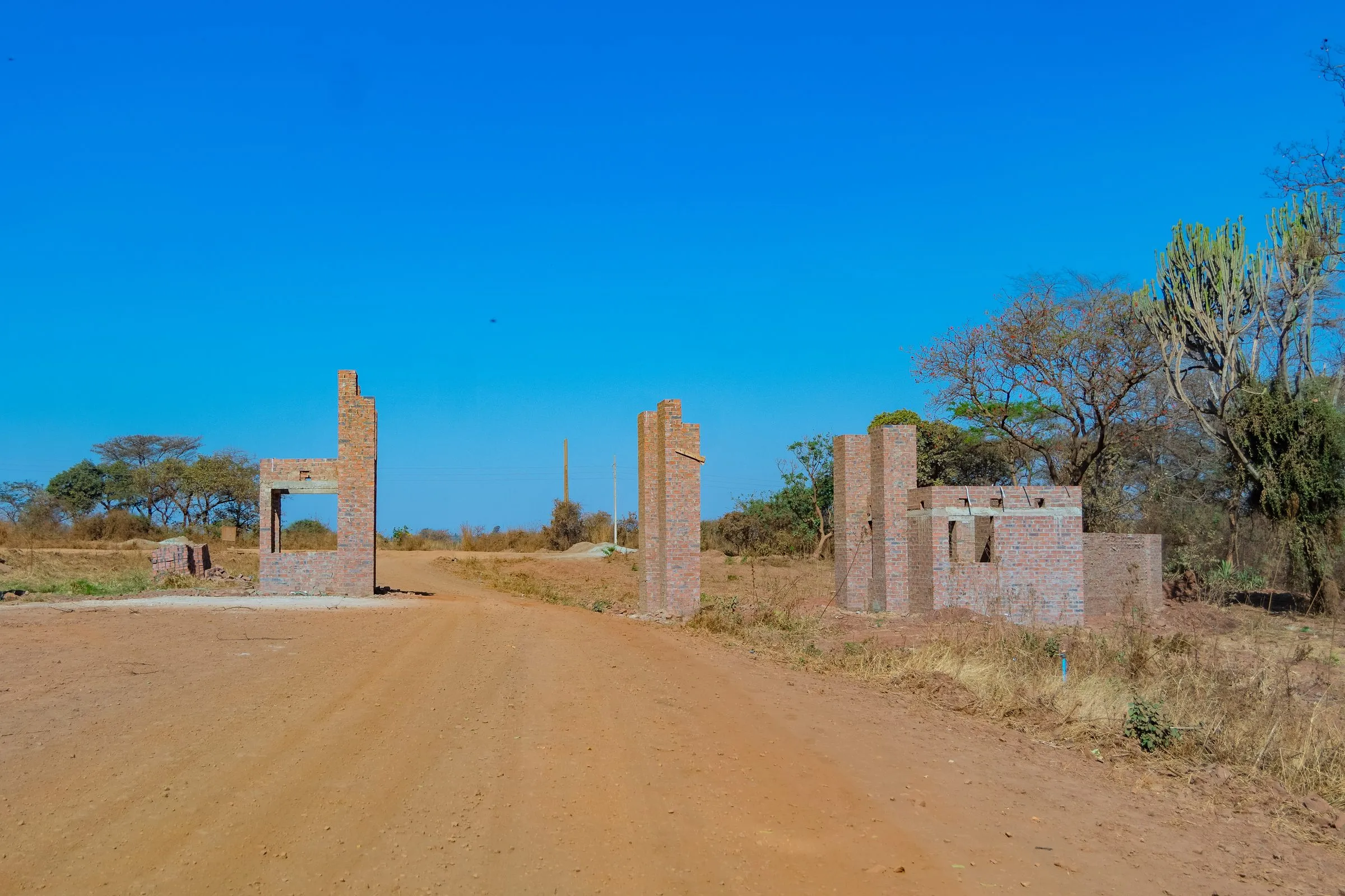 Estate entrance under construction, photographed 25 Aug 2026