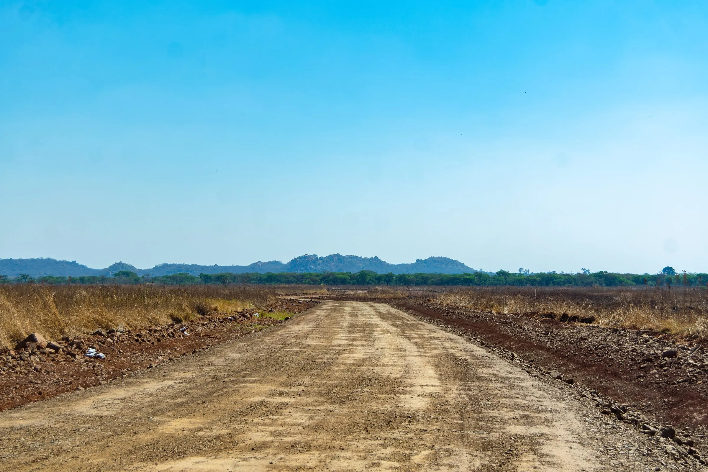 Graded road toward the hills, photographed 25 Aug 2026